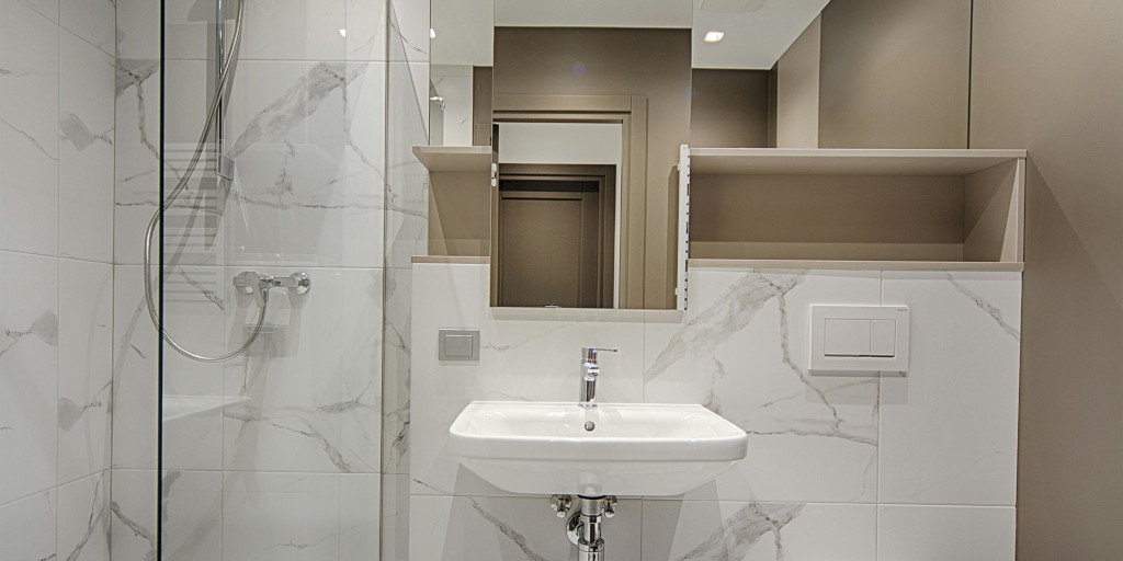 Bathroom with large format porcelain tiles on the floor and walls.